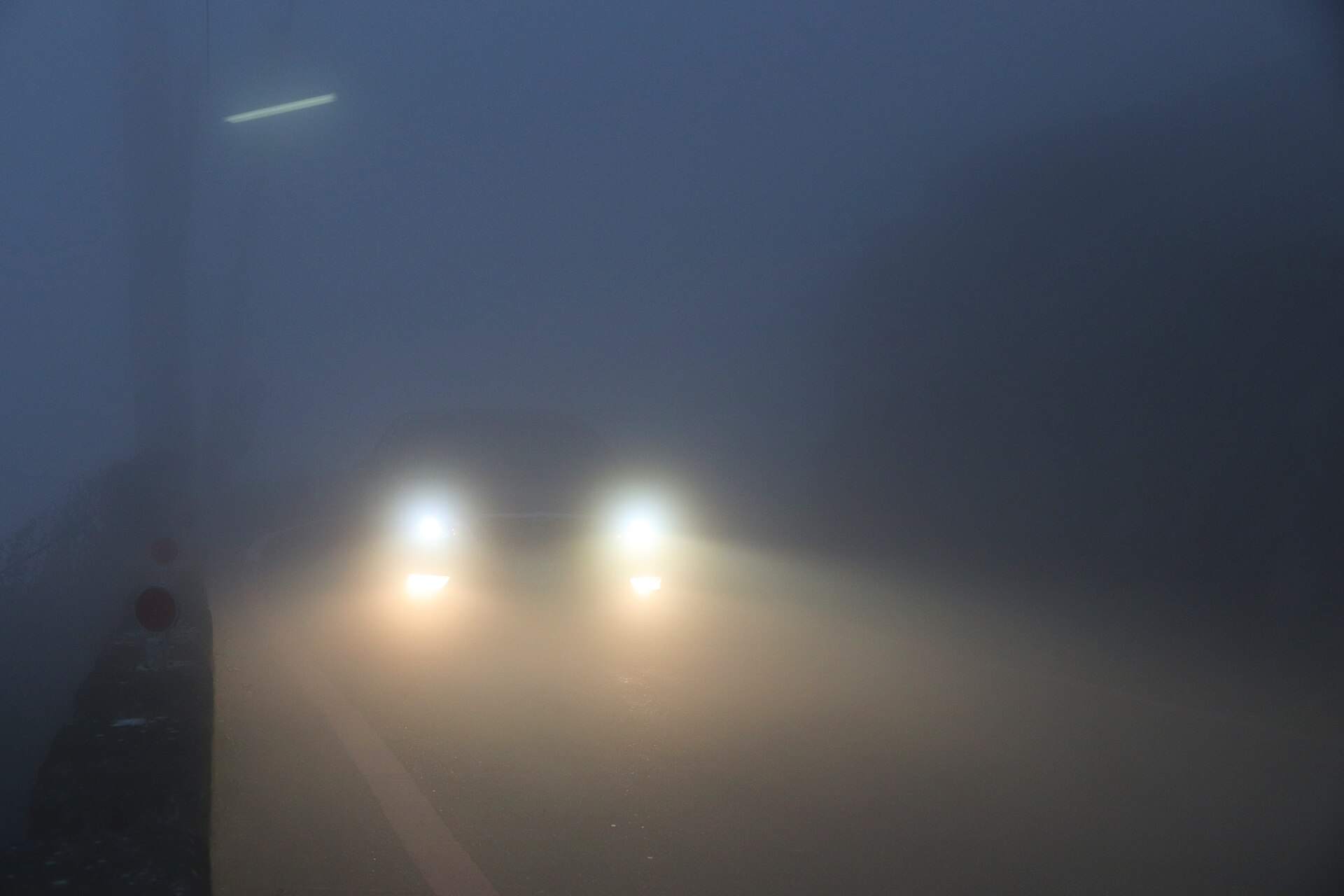 Car silhouette fading into fog at night representing Ghost Mode privacy on Spota