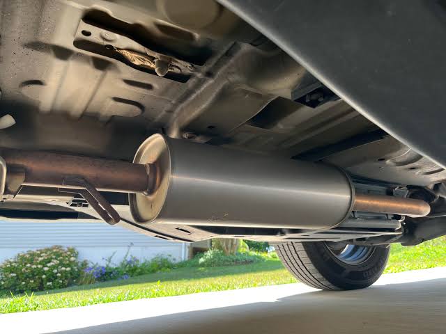 Underside view of a car showing the catalytic converter and exhaust system
