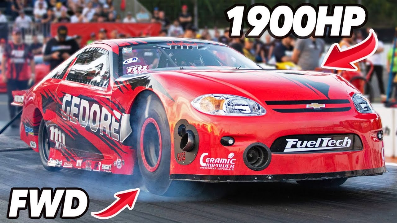 Front-wheel drive hot hatchback cornering hard on a track with visible torque steer and tire smoke